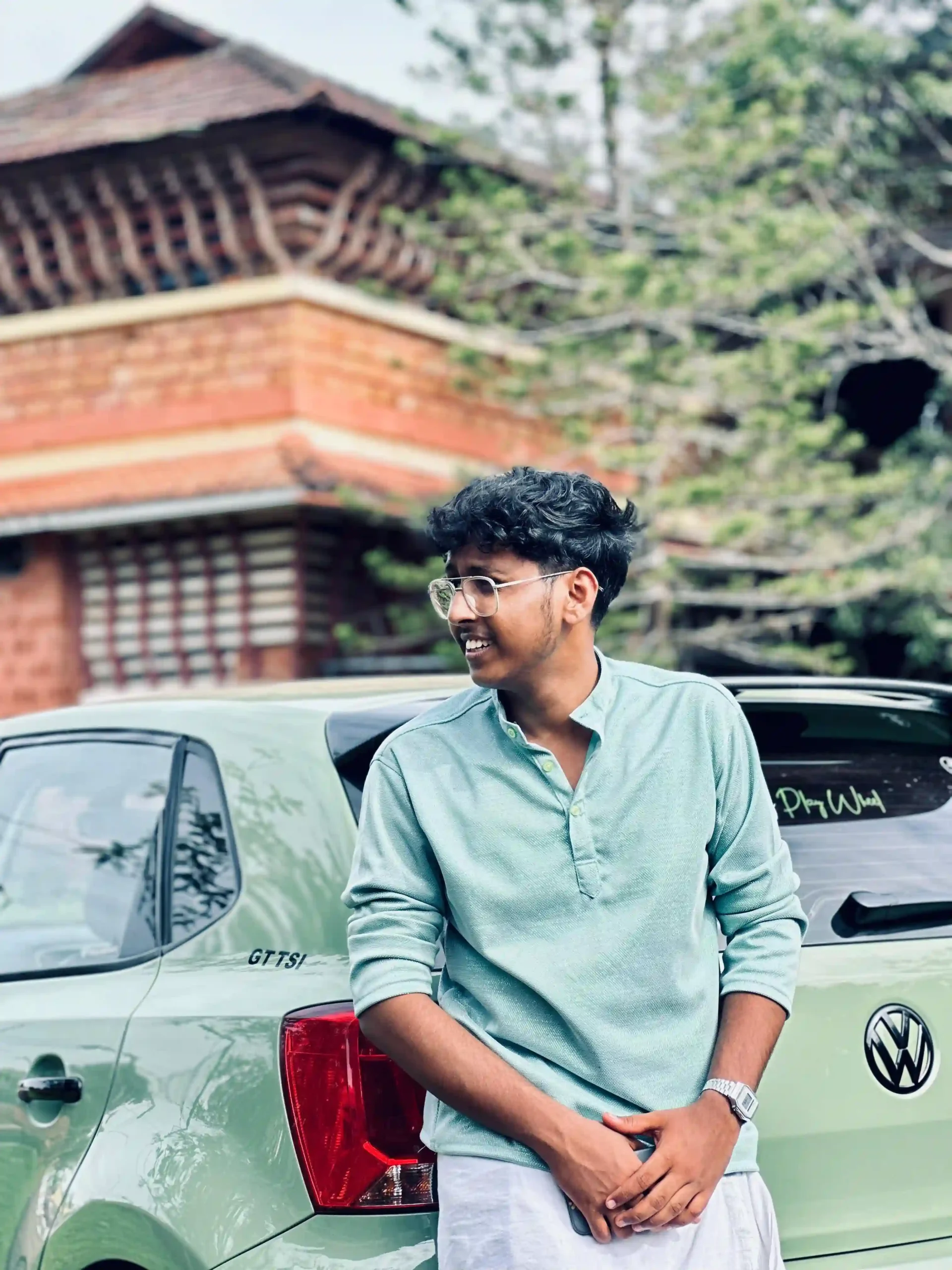 a freelance digital marketer expert in kannur standing behaind car